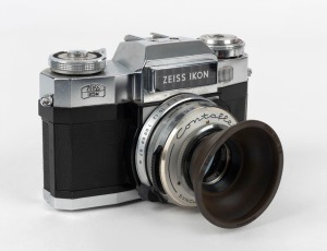 ZEISS IKON: Contaflex Super B SLR camera [#B.51832], circa 1962, with Tessar 50mm f2.8 lens [#3555248] and combination UV filter rubber lens hood.