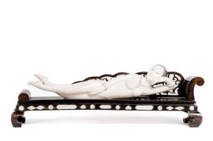 A Chinese ivory doctor's model on a carved and inlaid wood couch, 20th century, 46cm wide