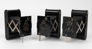 KODAK: Three early 1920s Vest Pocket Autographic folding cameras, each with varying body and lens details. The 'Autographic' feature enabled photographers to write a note onto the special film used in these cameras, which would become visible after develo