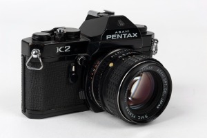 ASAHI KOGAKU: Black-body Pentax K2 SLR camera [#7118742], circa 1975, with SMC Pentax 50mm f1.4 lens [#1537556].