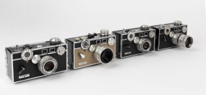 ARGUS: Four mid 20th-century rangefinder cameras - one Argus C3 Matchmatic [#1828461055], two Argus C3s [#700 570 & 820 232], and one Argus C2 [#68 997]. (4 cameras)