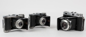 BALDA: Three early 1950s vertical-folding rangefinder cameras - one Super Baldax with Baldanar 80mm f3.5 lens [#3056], and two Mess-Rigona models with Rigonar 50mm f3.5 lenses, one with heavy print and one with light print letter detail. (3 cameras)