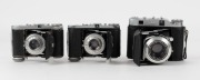 BALDA: Three early 1950s vertical-folding rangefinder cameras - one Super Baldax with Baldanar 80mm f3.5 lens [#3056], and two Mess-Rigona models with Rigonar 50mm f3.5 lenses, one with heavy print and one with light print letter detail. (3 cameras) - 2