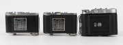 BALDA: Three early 1950s vertical-folding rangefinder cameras - one Super Baldax with Baldanar 80mm f3.5 lens [#3056], and two Mess-Rigona models with Rigonar 50mm f3.5 lenses, one with heavy print and one with light print letter detail. (3 cameras) - 3