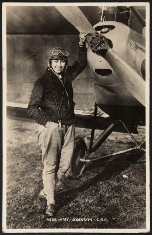 AN ARCHIVE OF AMY JOHNSON MEMORABILIA. The archive comprises: a signed postcard of Johnson standing next to her DH60G Gipsy Moth; Amy Johnson's fur-lined leather flying helmet by Pike Brothers of Brisbane; a leather-bound and boxed "Presentation [album] t