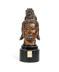 A Chinese parcel-gilt bronze head of Guanyin, 20th cenrtury, old fitted wood base, 30cm high and 44cm high including stand