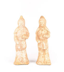 A pair of red pottery tomb figures of attendants, with traces of white pigment, Tang Dynasty 618-907, 35cm high