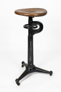 An antique industrial cast iron stool with elm seat, early 20th century, 81cm high.&nbsp;