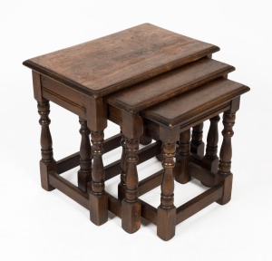 A vintage nest of three English oak occasional tables in the Tudor style, 20th century, the largest 48cm high, 55cm wide, 34cm deep