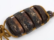 A fine antique Japanese Urushi gold leaf lacquered three case inro featuring a tiger on one side and a dragon on the reverse. Carved wooden netsuke with three aubergines representing happiness and prosperity, Edo period, 18th/19th century, 6.5cm high - 8