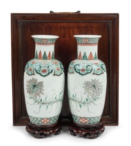 A pair of antique Chinese famille vert porcelain vases on later carved wooden stands, housed in a plush silk lined rosewood box, Qing Dynasty, 19th century. 25cm high