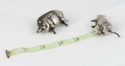 Antique sterling silver pig pin cushion, together with a sterling silver pig tape measure, (2 items), the larger 3.5cm high, 6cm long - 3