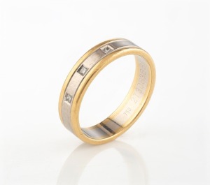 An 18ct gold two tone ring, set with three diamonds, stamped "750", 10.4 grams