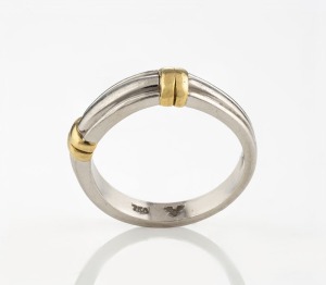 A platinum ring adorned with 18ct yellow gold bands, stamped "750, PLAT." with additional maker's marks (illegible), 11.5grams total