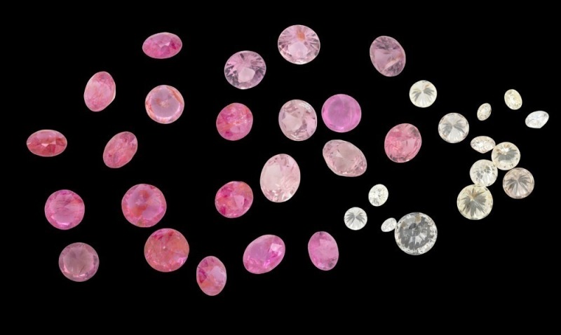 Collection of assorted loose stones including diamonds and pink stones