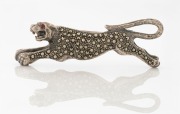 An Art Deco&nbsp;silver and marcasite panther brooch with ruby set eye, ​​​​​​​6.5cm wide, 20 grams