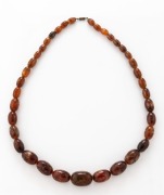 A graduated brown amber bead necklace, 20th century, 70cm long