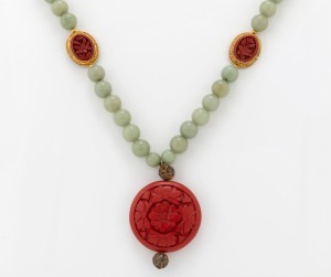 A Chinese jade bead necklace with cinnabar lacquered pendant and spacers set in filigree gilt silver, 20th century, 56cm long