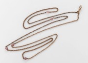 An antique gold plated muff chain with pink stone beads, 19th century, 128cm long