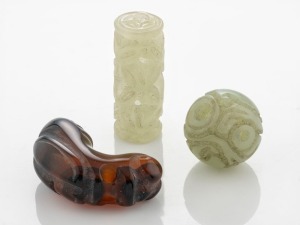 Three antique Chinese carved jade beads, the largest 3.7cm wide