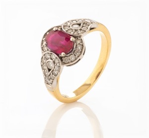 An 18ct yellow gold ring, set with a cut ruby surrounded by pave set diamonds in white gold, stamped "750", 4.1 grams