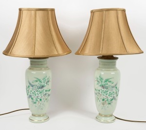 A pair of antique glass table lamp bases with hand-painted enamel floral decorations and later gold shades, ​​​​​​​70cm high overall