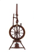 An antique German parlour spinning wheel, turned and stained beech with carved bone and porcelain decoration, 19th century, 116cm high