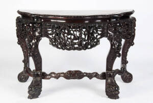 A heavy Chinese hardwood and marble top console table with four dragon form legs, early 20th century, 81cm high, 125cm wide and 63cm deep