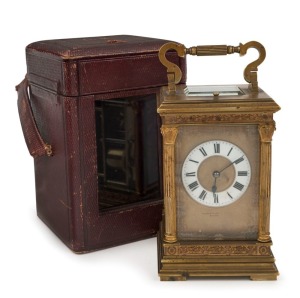 An antique French Anglais cased carriage clock, eight day time and gong striking movement with push button repeat, manufactured by E. M. & Co., enamel chapter ring with Roman numerals and gilt dial mask, English retailer's name, original Moroccan leather carrying case and numbered key, the clock 20cm high