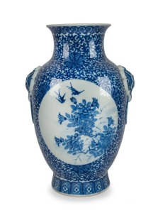 A Chinese ornate blue and white porcelain vase, adorned with vignettes of water scenes, landscapes, birds and blossoms, Guan Xu mark to base, 19th/20th century, 35cm high