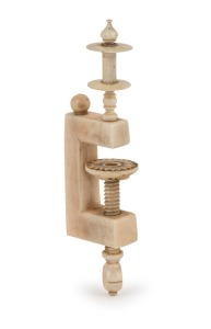 An antique turned and carved ivory bobbin hold with sewing table mount, 19th century, ​​​​​​​10cm high