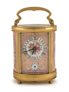 An antique French oval and porcelain panelled carriage clock timepiece with bell chiming alarm mechanism, gilt decorated dial and panels with musical motifs, circa 1900, engraved to the top "9 Août, 1906", 14cm high