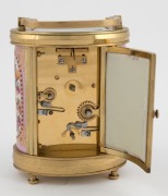 An antique French oval and porcelain panelled carriage clock timepiece with bell chiming alarm mechanism, gilt decorated dial and panels with musical motifs, circa 1900, engraved to the top "9 Août, 1906", 14cm high - 4