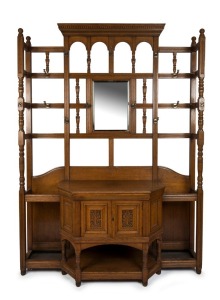 An antique English wing sided hall stand of impressive proportions, oak with carved decoration to the lower cupboard and original brass hardware, 19th century, 240cm high, 175cm wide, 50cm deep