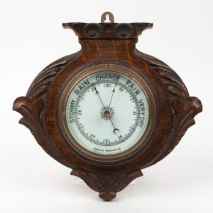 An antique aneroid barometer in oak case, 19th century, ​​​​​​​27cm high.