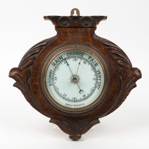 An antique aneroid barometer in oak case, 19th century, 27cm high.