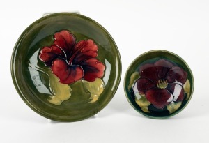 MOORCROFT two English pottery bowls with floral decoration on celadon green grounds, circa 1930s, both bearing original paper labels, ​​​​​​​the larger 18cm diameter