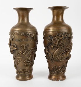 A pair of Chinese cast bronze dragon and phoenix vases, 20th century, 28cm high