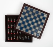 The Battle of Waterloo Chess Set, by Franklin Mint, 1987, 32 pewter chessmen on red and blue enamelled pedestals; the pewter-finished playing area with timber case. The top of the chess board lifts to reveal separate storage compartments for each of the t