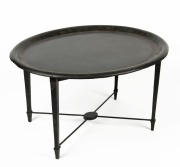An oval papier-m&acirc;ch&eacute; topped tray stand table, 45cm high, 77cm wide, 63cm deep