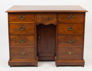 An antique English mahogany knee-hole desk with inverted break front, made in the Georgian style, mid 19th century, 82cm high, 108cm wide, 53cm deep