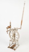 An antique turned beech spinning wheel with remains of white painted finish, 19th century, ​​​​​​​144cm high