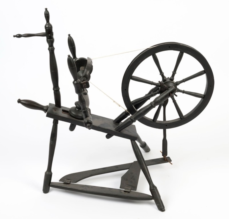 An antique turned beech spinning wheel with ebonized finish, 19th century, ​​​​​​​70cm high