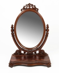An antique English mahogany dressing mirror, serpentine plinth base with scroll feet, oval mirror with well carved supports, 19th century, 93cm high, 66cm wide, 29cm deep