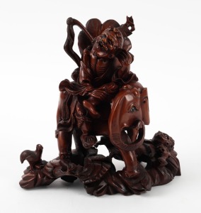 A Chinese carved box wood figural group of a man on a elephant 20th century, 26cm high.