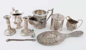 Sterling silver hand mirror, jug and candlesticks, together with a silver plated shaving mug, cup, jar and a scent bottle, (8 items) the mirror 25cm long