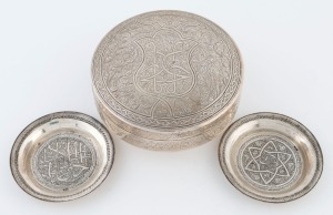 A Persian silver circular box, together with two small dishes, 20th century, (3 items), the box 5.5cm high, 11.5cm diameter, 264 grams total
