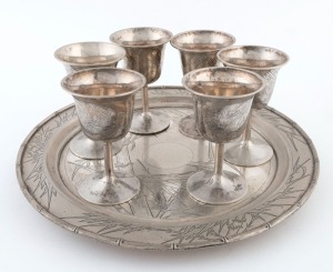 A Chinese export silver drinks set with bamboo decoration comprising of a serving tray and six goblets, 19th/20th century, (7 items), stamped "U.F.F. STERLING", the tray 30cm diameter, 1164 grams total