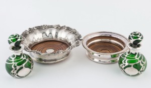 Two silver plated bottle coasters, together with a pair a green glass scent bottles with silver overlay, 19th/20th century, (4 items), the largest bowl 20cm diameter.