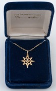 THE WISHING STAR PENDANT by Herman de Roos, 14ct gold star pendant adorned with a ten point brilliant cut white diamond on 14ct gold chain, in original box, 5.1 grams total